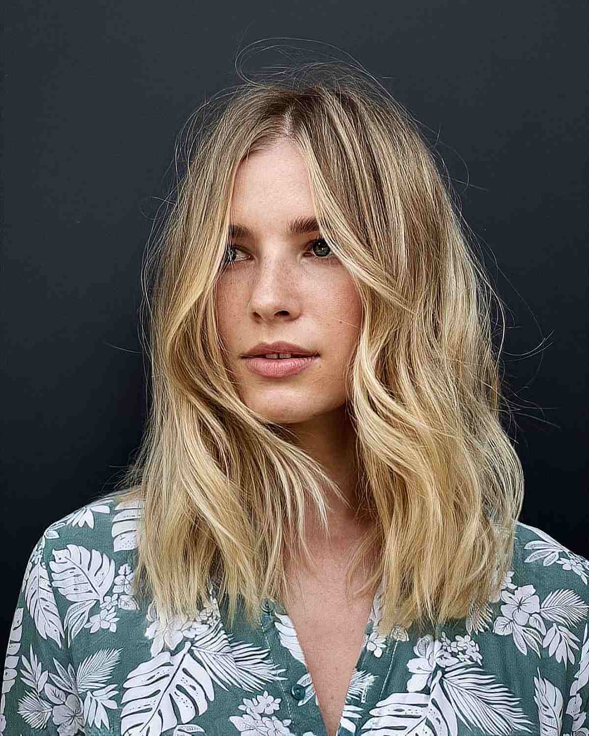 Modern Blonde Shaggy Haircut with a Center Part for Fine Hair