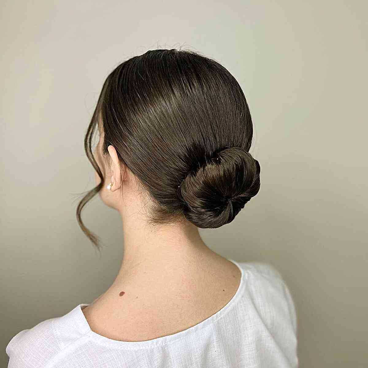 Easy Formal Ballerina Updo Bun with Face-Framing Strands on Dark Hair