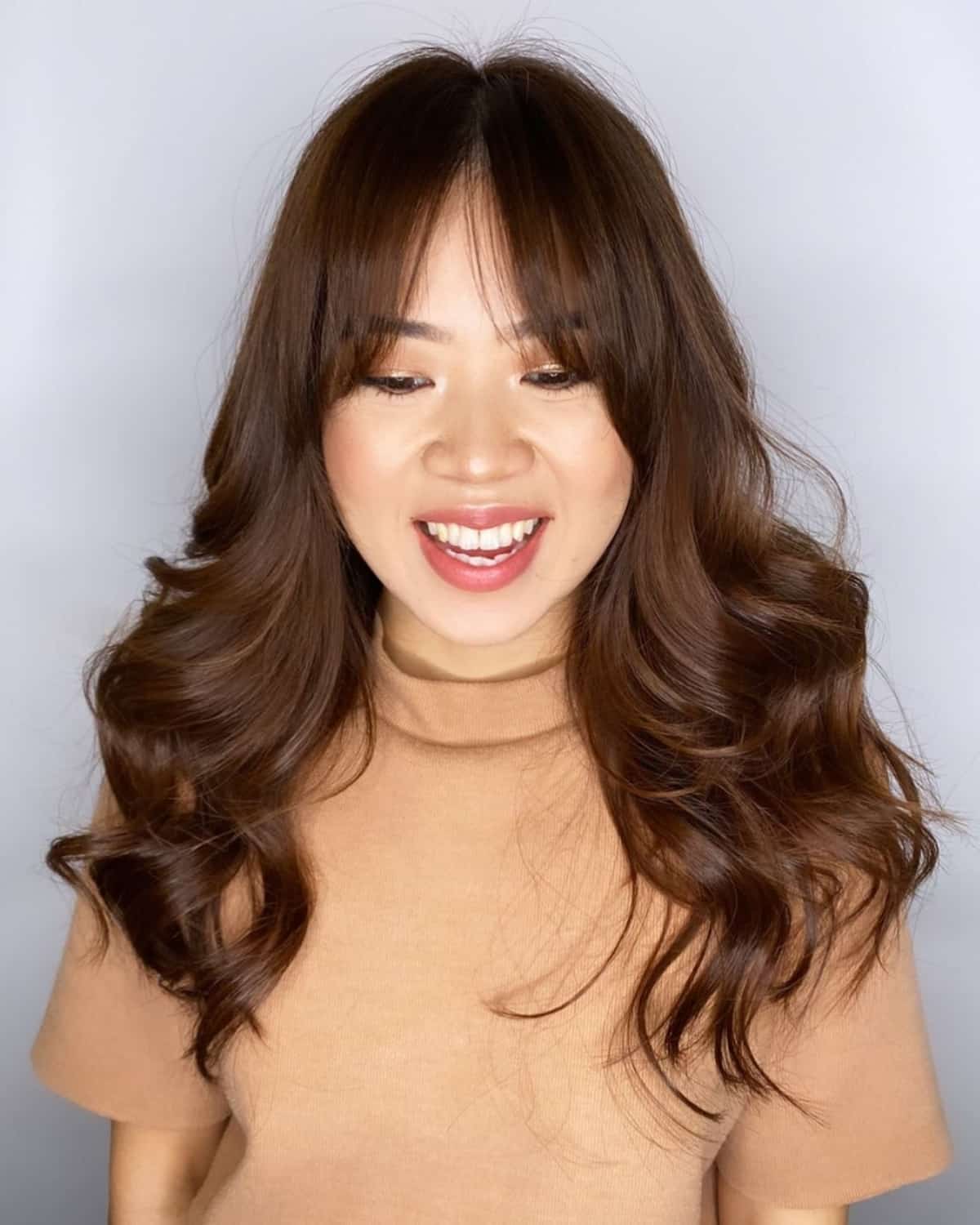 Feminine Face-Framing Curtain Bangs Hairstyle