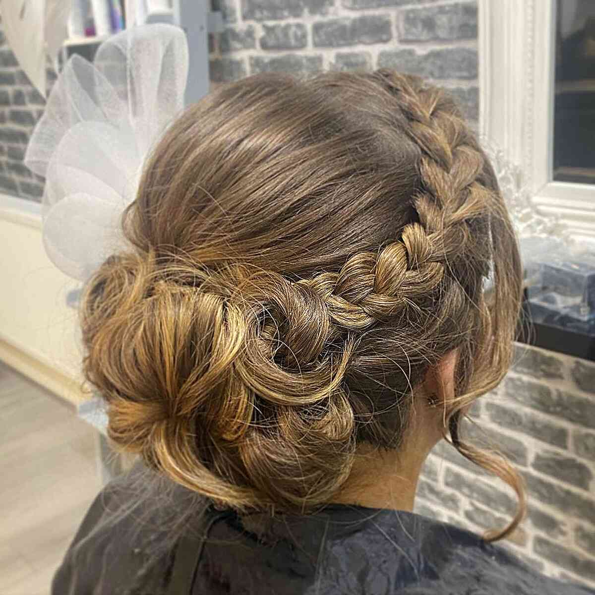 Golden Brown Messy Low Bun with Dutch Braids