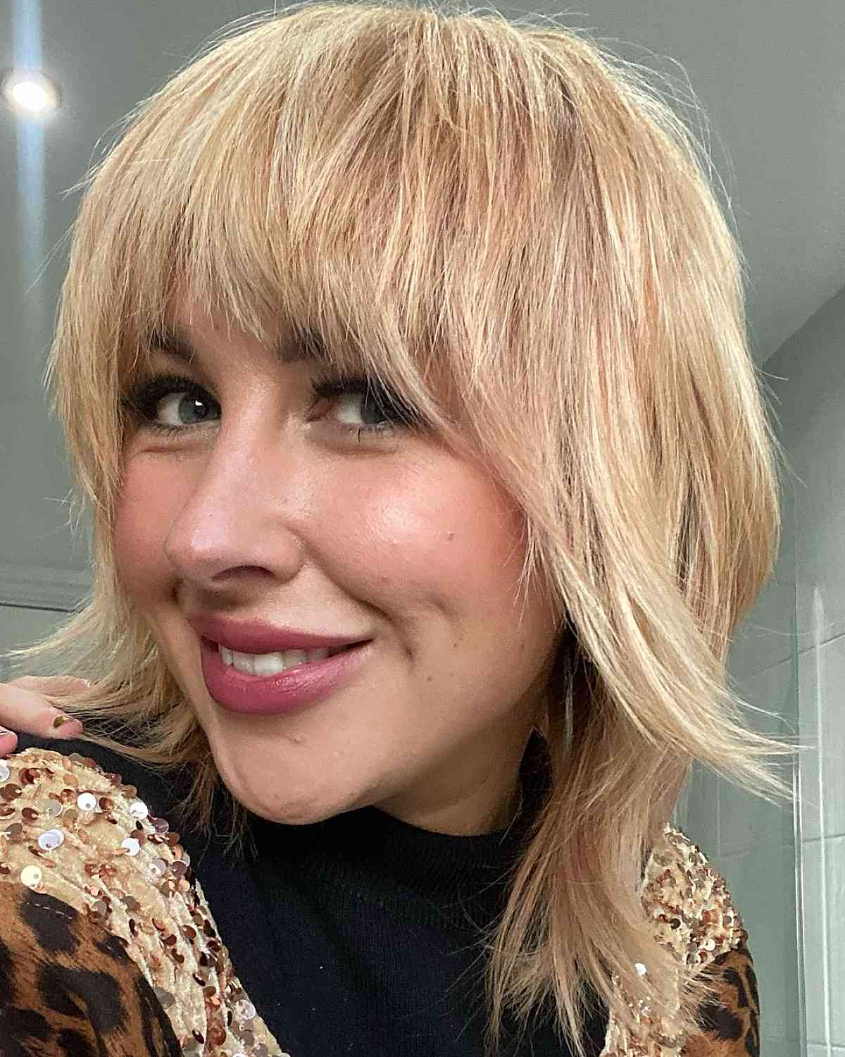 Cute blonde shaggy bob with bangs