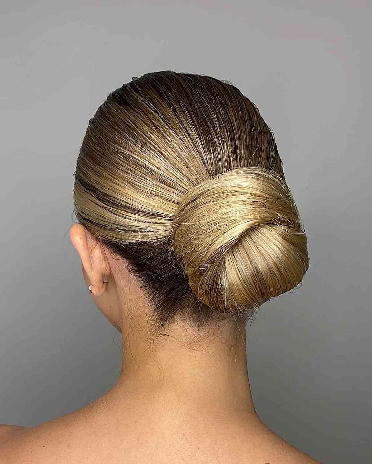 Sleek Blonde Low-Styled Bun Updo for Straighter Locks