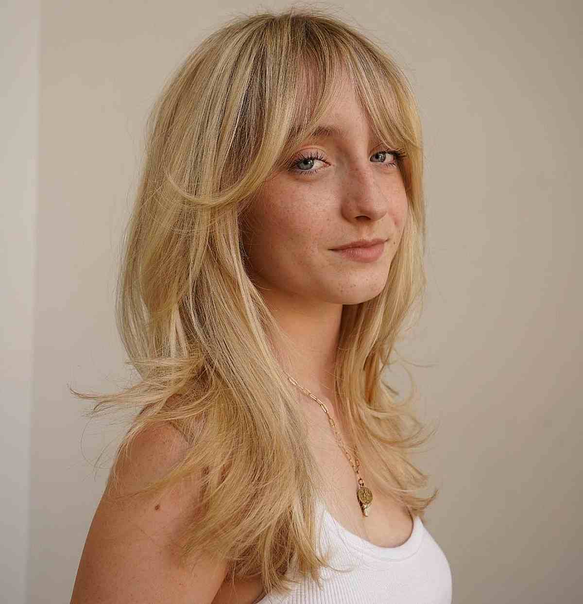 Soft & stunning curtain bangs on long blonde hair